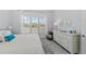 Bright bedroom with large window, white dresser, and serene decor at 8067 Waterbend Trl, Sarasota, FL 34240