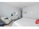 Bright bedroom featuring a rocking chair, dresser, and modern ceiling fan at 8067 Waterbend Trl, Sarasota, FL 34240