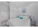 Comfortable bedroom featuring a queen bed, soft lighting, and light-colored walls at 8067 Waterbend Trl, Sarasota, FL 34240
