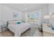 Bright bedroom with a large window, shutters, and a comfortable bed with decorative pillows at 8067 Waterbend Trl, Sarasota, FL 34240