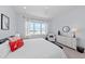 Bright bedroom with a large window overlooking the lake at 8067 Waterbend Trl, Sarasota, FL 34240
