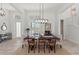 Elegant dining room features a large table perfect for gatherings with ample natural light at 8067 Waterbend Trl, Sarasota, FL 34240