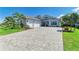 Charming single-Gathering home with a well-manicured lawn, paver driveway, and a three-car garage at 8067 Waterbend Trl, Sarasota, FL 34240