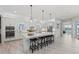 Bright kitchen with white cabinets, large island, and pendant lighting at 8067 Waterbend Trl, Sarasota, FL 34240