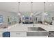 Open concept kitchen with island seating and access to living room at 8067 Waterbend Trl, Sarasota, FL 34240