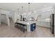 Open-concept kitchen featuring a large island with seating and modern appliances at 8067 Waterbend Trl, Sarasota, FL 34240