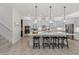 Stylish kitchen with white cabinets, large island, and stainless steel appliances at 8067 Waterbend Trl, Sarasota, FL 34240