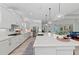 Modern kitchen island with sink and view of the living area at 8067 Waterbend Trl, Sarasota, FL 34240