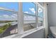 Windows showcase a serene lake view, enhancing the room's tranquil atmosphere at 8067 Waterbend Trl, Sarasota, FL 34240