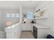 Second floor landing with a beverage bar and natural light at 8067 Waterbend Trl, Sarasota, FL 34240
