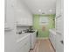 Bright laundry room with modern appliances and ample cabinet space at 8067 Waterbend Trl, Sarasota, FL 34240