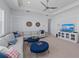 Bright living room with large sectional seating, tray ceiling, and entertainment center at 8067 Waterbend Trl, Sarasota, FL 34240