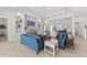 Comfortable living room with blue couches, stylish lighting, and elegant shelving units at 8067 Waterbend Trl, Sarasota, FL 34240