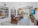 Inviting living room featuring comfortable seating, built-in bookshelves, and a picturesque lake view at 8067 Waterbend Trl, Sarasota, FL 34240
