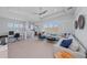 Upstairs loft space with a large sofa, workstation and beverage bar at 8067 Waterbend Trl, Sarasota, FL 34240