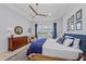 Spacious main bedroom with a tray ceiling, ceiling fan, lake view, and traditional furnishings at 8067 Waterbend Trl, Sarasota, FL 34240