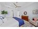 Bright and airy main bedroom featuring tray ceilings, a ceiling fan, lake view, and a classic furniture set at 8067 Waterbend Trl, Sarasota, FL 34240