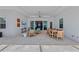 Expansive outdoor living space with travertine, dining area, and comfortable lounging furniture at 8067 Waterbend Trl, Sarasota, FL 34240