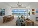 Spacious outdoor living area with pool, lake views, dining, and comfortable seating at 8067 Waterbend Trl, Sarasota, FL 34240