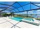 Screened-in pool and spa overlooking a serene lake view on a sunny day at 8067 Waterbend Trl, Sarasota, FL 34240