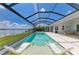Screened pool and spa with chairs and a lake view provides a relaxing retreat at 8067 Waterbend Trl, Sarasota, FL 34240