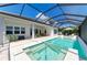 Covered patio and screened pool with spa offers an ideal indoor-outdoor lifestyle at 8067 Waterbend Trl, Sarasota, FL 34240