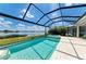 Screened pool and spa with a lake view on a bright day at 8067 Waterbend Trl, Sarasota, FL 34240