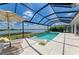 Screened pool and spa with lounge chairs and a lake view offer relaxation at 8067 Waterbend Trl, Sarasota, FL 34240