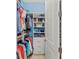 Walk-in closet with custom shelving and hanging rods for neatly organized storage at 8067 Waterbend Trl, Sarasota, FL 34240
