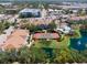 Aerial view of community amenities including a tennis court, pool, and lush landscaping in a residential area at 850 S Tamiami Trl # 836, Sarasota, FL 34236