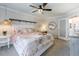 Cozy bedroom features a ceiling fan, bedside table, and large bed with decorative pillows and a soft blanket at 850 S Tamiami Trl # 836, Sarasota, FL 34236