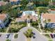 Aerial view of a clubhouse with manicured landscaping, a swimming pool, and ample parking at 850 S Tamiami Trl # 836, Sarasota, FL 34236
