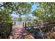 Scenic waterfront view from a wooden dock surrounded by lush greenery and glimpses of neighboring houses at 850 S Tamiami Trl # 836, Sarasota, FL 34236
