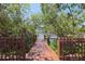 Wooden dock amidst lush trees leading to the water, offering a tranquil and private waterfront access at 850 S Tamiami Trl # 836, Sarasota, FL 34236