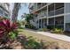 Charming condo building with white railings, lush landscaping, and a well-maintained lawn at 850 S Tamiami Trl # 836, Sarasota, FL 34236