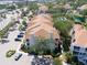 Aerial view showcases residential building with balconies, surrounded by lush greenery and parking areas at 850 S Tamiami Trl # 836, Sarasota, FL 34236