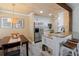 Modern kitchen with stainless steel appliances, breakfast bar, and a dining area at 850 S Tamiami Trl # 836, Sarasota, FL 34236