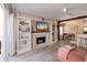 Stylish living room with built-in shelving, fireplace, and a ceiling fan at 850 S Tamiami Trl # 836, Sarasota, FL 34236
