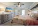 Comfortable bedroom featuring a dresser, TV and access to the balcony with ample space at 850 S Tamiami Trl # 836, Sarasota, FL 34236