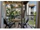 Inviting screened patio area offering outdoor relaxation with tropical landscaping views at 850 S Tamiami Trl # 836, Sarasota, FL 34236