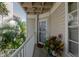 Inviting porch with potted plants and a view of the surrounding greenery at 850 S Tamiami Trl # 836, Sarasota, FL 34236