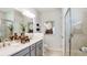 Modern bathroom with double sinks, a walk-in shower, and stylish decor for a spa-like experience at 8561 Snowfall St, Sarasota, FL 34241