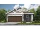 Charming single-story home with a two-car garage, neutral paint scheme, and well-maintained landscaping at 8561 Snowfall St, Sarasota, FL 34241