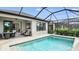 Inviting outdoor pool and patio area with comfortable seating and a screened-in enclosure at 8561 Snowfall St, Sarasota, FL 34241