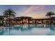 Stunning community pool with ample lounge chairs and umbrellas, set against a beautiful building at 8561 Snowfall St, Sarasota, FL 34241