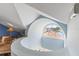 Bright attic with unique arched window and cozy sitting area with a blue accent wall and stylish furniture at 861 Nectar Rd, Venice, FL 34293