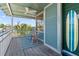 Charming porch with rocking chairs and surfboard decor, creating a relaxed and inviting outdoor space at 861 Nectar Rd, Venice, FL 34293