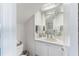 Well-lit bathroom with a unique mirrored ceiling, vanity with a white sink, and coastal-themed decor at 861 Nectar Rd, Venice, FL 34293