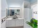 Stylish bathroom with blue accents, a spacious vanity, and a modern glass-enclosed shower at 861 Nectar Rd, Venice, FL 34293