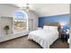 Bright bedroom with a large arched window, neutral colors, and plenty of natural light at 861 Nectar Rd, Venice, FL 34293